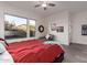 Spacious bedroom with red bedding and large windows at 13162 W Duane Ln, Peoria, AZ 85383