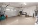 Spacious garage with overhead storage and ample space for vehicles and storage at 13162 W Duane Ln, Peoria, AZ 85383