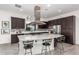 Modern kitchen with island, stainless steel appliances, and dark cabinetry at 13162 W Duane Ln, Peoria, AZ 85383