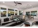 Spacious living area with gray sectional and large windows at 13162 W Duane Ln, Peoria, AZ 85383