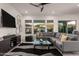 Living room with gray sectional sofa and large TV at 13162 W Duane Ln, Peoria, AZ 85383