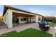 Large backyard patio with seating area and artificial grass at 13162 W Duane Ln, Peoria, AZ 85383