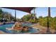 Community pool with a rock waterfall and plenty of lounge chairs at 13162 W Duane Ln, Peoria, AZ 85383