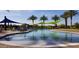 Community pool with shade structures and plenty of lounge chairs at 13162 W Duane Ln, Peoria, AZ 85383