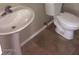 Small bathroom with pedestal sink and tile floor at 14737 N 174Th Dr, Surprise, AZ 85388
