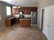 Open kitchen with tile floor and wood cabinets at 14737 N 174Th Dr, Surprise, AZ 85388