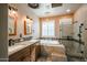 Bathroom boasts double vanity, jetted tub, and walk-in shower at 14959 W Winged Foot Ct, Surprise, AZ 85374