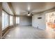 Bright living room featuring wood-look floors and a ceiling fan at 14959 W Winged Foot Ct, Surprise, AZ 85374