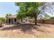Large backyard with gravel, tree, and block wall at 15306 W Eureka Trl, Surprise, AZ 85374