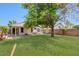 Spacious backyard featuring a well-maintained lawn and a covered patio, perfect for outdoor entertaining and relaxation at 15306 W Eureka Trl, Surprise, AZ 85374