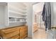 Spacious bedroom closet with built-in shelves and dresser at 15306 W Eureka Trl, Surprise, AZ 85374