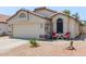 Charming single-story home with a two-car garage and well-maintained landscaping at 15306 W Eureka Trl, Surprise, AZ 85374