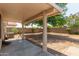 Covered patio with small table and view of backyard at 15306 W Eureka Trl, Surprise, AZ 85374