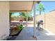 Covered patio with grill, playhouse, and view of the serene, enclosed backyard at 15306 W Eureka Trl, Surprise, AZ 85374