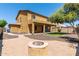 Large backyard with covered patio, fire pit, and artificial turf at 16109 W Christy Dr, Surprise, AZ 85379
