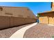 Landscaped backyard with pathway and wall at 16109 W Christy Dr, Surprise, AZ 85379
