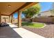 Covered patio with artificial turf and rock at 16109 W Christy Dr, Surprise, AZ 85379