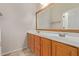 Double vanity bathroom with wood cabinets and large mirror at 16109 W Christy Dr, Surprise, AZ 85379