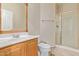 Bathroom with single vanity, shower and wood cabinet at 16109 W Christy Dr, Surprise, AZ 85379