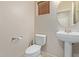 Clean bathroom with pedestal sink, toilet and tile flooring at 16109 W Christy Dr, Surprise, AZ 85379