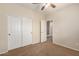 Bright bedroom with double door closet and carpet flooring at 16109 W Christy Dr, Surprise, AZ 85379