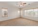 Spacious bedroom with ceiling fan and large windows at 16109 W Christy Dr, Surprise, AZ 85379