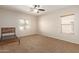Bedroom with two windows, ceiling fan and carpet floor at 16109 W Christy Dr, Surprise, AZ 85379