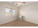 Spacious bedroom with window, ceiling fan and carpet at 16109 W Christy Dr, Surprise, AZ 85379