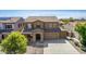 Two-story house with stone accents, two-car garage, and landscaped front yard at 16109 W Christy Dr, Surprise, AZ 85379