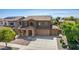 Two-story house with stone accents, two-car garage, and landscaped front yard at 16109 W Christy Dr, Surprise, AZ 85379