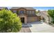 Two-story house with stone accents, two-car garage, and landscaped front yard at 16109 W Christy Dr, Surprise, AZ 85379