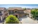 Two-story house with stone accents, two-car garage, and landscaped front yard at 16109 W Christy Dr, Surprise, AZ 85379