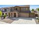 Two-story house with stone accents and two-car garage at 16109 W Christy Dr, Surprise, AZ 85379
