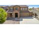 Two-story house with stone accents and two-car garage at 16109 W Christy Dr, Surprise, AZ 85379