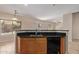 Kitchen features a large island with sink, dishwasher, and breakfast bar at 16109 W Christy Dr, Surprise, AZ 85379