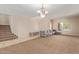 Living room with tile floors, chandelier, and staircase at 16109 W Christy Dr, Surprise, AZ 85379