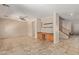 Open living room with tile flooring and built-in shelving at 16109 W Christy Dr, Surprise, AZ 85379