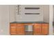 Built-in wet bar with wood cabinets and granite countertop at 16109 W Christy Dr, Surprise, AZ 85379