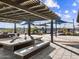 Outdoor kitchen and dining area with pergola at 17675 W Amber Dr, Goodyear, AZ 85338