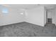 Bright bedroom with plush carpeting, two windows and an en-suite bathroom at 17815 W Denton Ave, Litchfield Park, AZ 85340
