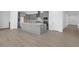 Open floor plan: Modern kitchen flows into the living space with stylish wood look tile floors at 17815 W Denton Ave, Litchfield Park, AZ 85340
