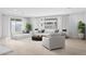 Bright living room with modern furnishings, including a white sofa and plush pillows, with natural light at 17815 W Denton Ave, Litchfield Park, AZ 85340