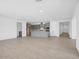 Open floor plan: Kitchen island flows into the dining and living space with stylish wood look tile floors at 17815 W Denton Ave, Litchfield Park, AZ 85340
