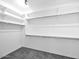 Walk-in closet with built-in shelving and three hanging rods at 17815 W Denton Ave, Litchfield Park, AZ 85340