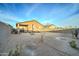 Desert backyard with patio and small trees at 19945 W Badgett Ln, Litchfield Park, AZ 85340