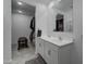 Bathroom with double vanity, large mirror, and walk-in closet at 19945 W Badgett Ln, Litchfield Park, AZ 85340
