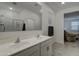 Bathroom boasts double sinks, a large mirror, and shower at 19945 W Badgett Ln, Litchfield Park, AZ 85340