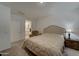 Main bedroom with a comfortable bed and en-suite bathroom access at 19945 W Badgett Ln, Litchfield Park, AZ 85340