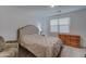 Bedroom with a queen bed, dresser, and window with blinds at 19945 W Badgett Ln, Litchfield Park, AZ 85340
