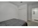 Bright bedroom with double door closet and view of additional room at 19945 W Badgett Ln, Litchfield Park, AZ 85340